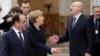 German Chancellor Angela Merkel (C) and French President Francois Hollande (L) say goodbye to Belarusian President Alyaksandr Lukashenka (R) as they leave the Ukrainian peace negotiations in Minsk, February 12, 2015