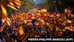 Spain -- Protesters wave Spanish and Catalan Senyera flags during a pro-unity demonstration in Barcelona on October 29, 2017