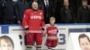 Belarus -- President Alyaksandr Lukashenka and his son Nikolay stand behind portraits of Marat Kalimullin (L) and Ruslan Salei during a commemorative event at the Minsk-Arena sports complex in Minsk.