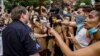 U.S. -- Demonstrators react in the presence of a New York Police Department (NYPD) police officer at a joint LGBTQ and Black Lives Matter march on the 51st anniversary of the Stonewall riots in New York City, New York, U.S. June 28, 2020. REUTERS/Eduardo 